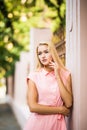 Young smiling blonde hair woman on the city streets on sunny day. Royalty Free Stock Photo