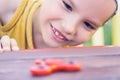 Young boy play with fidget spinner stress relieving toy Royalty Free Stock Photo