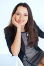 Young smiling brunette business woman sitting on a chair Royalty Free Stock Photo