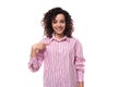young smiling brunette curly caucasian woman dressed in a striped pink blouse isolated on white background. people Royalty Free Stock Photo