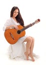 Young smiling brunette lady playing guitar Royalty Free Stock Photo