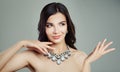 Young smiling brunette woman pointing to the side and showing Royalty Free Stock Photo