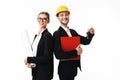 Young smiling business man in yellow safety helmet with folder and keys of new flat in hands and woman in eyeglasses