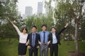 Young smiling business people in the park, portrait in a row Royalty Free Stock Photo