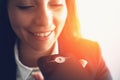 Young smiling business woman using smart phone voice message recognition or vocal digital AI assistant Royalty Free Stock Photo