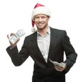 Young smiling businessman in santa hat holding money Royalty Free Stock Photo