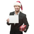 Young smiling businessman in santa hat holding sign Royalty Free Stock Photo