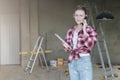 Young smiling businesswoman builder,engineer, architect,designer in construction glasses is standing in workshop Royalty Free Stock Photo