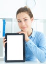 Young smiling businesswoman holding tablet in hands sitting at office. Royalty Free Stock Photo