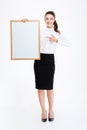 Young smiling businesswoman poiting finger at blank board Royalty Free Stock Photo