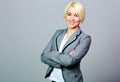 Young smiling businesswoman standing with arms folded Royalty Free Stock Photo