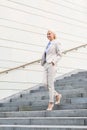 Young smiling businesswoman walking down stairs Royalty Free Stock Photo