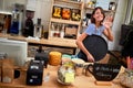 Young cafe business owner standing at bar in cafe store- Woman barista
