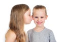 Young smiling caucasian boy and girl kisses him on the cheek