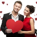 Young smiling caucasian couple holding red heart Royalty Free Stock Photo