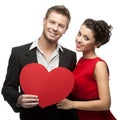 Young smiling caucasian couple holding red heart Royalty Free Stock Photo