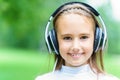 Young smiling caucasian girl listening music with professional DJ headphones and getting fun