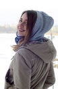 A young and smiling Caucasian girl looks around the horizon line between the sky and the frozen lake Royalty Free Stock Photo