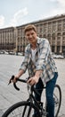 Man with his bicycle during riding on city square Royalty Free Stock Photo