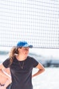 Young smiling caucasian woman behind the net playing beach volleyball Royalty Free Stock Photo