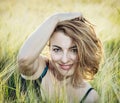 Young smiling caucasian woman posing in the wheat field, beauty