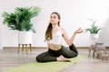 Young smiling Caucasian woman practicing yoga, sitting on green mat in One Legged King Pigeon exercise, Eka Pada Royalty Free Stock Photo