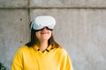 Young smiling caucasian woman using VR headset, looking up in virtual reality Royalty Free Stock Photo