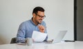 Young smiling cheerful businessman in office on video conference call