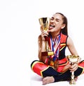 young smiling cheerleader girl with golden cups and price medals isolated on white background, lifestyle sport people Royalty Free Stock Photo