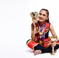 young smiling cheerleader girl with golden cups and price medals isolated on white background, lifestyle sport people Royalty Free Stock Photo