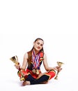 young smiling cheerleader girl with golden cups and price medals isolated on white background, lifestyle sport people Royalty Free Stock Photo