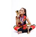 young smiling cheerleader girl with golden cups and price medals isolated on white background, lifestyle sport people Royalty Free Stock Photo