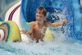 Young smiling child having fun in aquapark