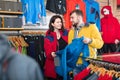 Couple choosing jacket in store Royalty Free Stock Photo