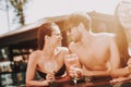 Young Smiling Couple with Cocktails at Poolside Royalty Free Stock Photo