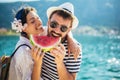 Smiling couple eating watermelon on the beach having fun Royalty Free Stock Photo