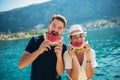 Smiling couple eating watermelon on the beach having fun Royalty Free Stock Photo