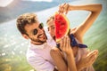 Smiling couple eating watermelon on the beach having fun Royalty Free Stock Photo