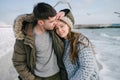 young smiling couple embracing on winter sea shore Royalty Free Stock Photo