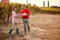 Young couple with grape in the vineyard