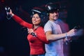 Young smiling couple having fun together, play with VR headsets and controllers. Royalty Free Stock Photo