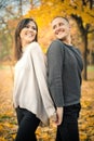 Young smiling couple having fun together on weekends in autumn park Royalty Free Stock Photo