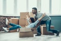 Young Smiling Couple Having Fun Unpacking Boxes Royalty Free Stock Photo