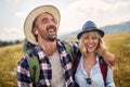 young smiling couple hiking in countryside and having fun. happy people travelling in nature