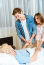 Young smiling couple holding hands of an elderly woman Royalty Free Stock Photo