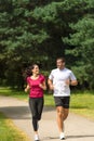 Young smiling couple running in park Royalty Free Stock Photo