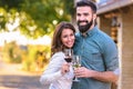 Young smiling couple tasting wine at winery outdoors Royalty Free Stock Photo