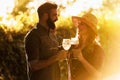 Young smiling couple tasting wine at winery vineyard Royalty Free Stock Photo