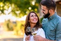 Young smiling couple tasting wine at winery outdoors Royalty Free Stock Photo