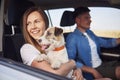 Young couple and their dog traveling together in a car Royalty Free Stock Photo